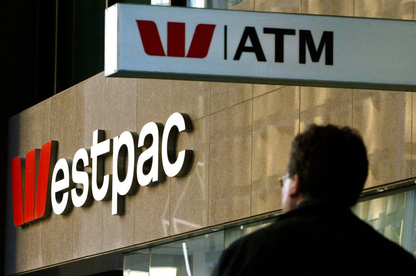 A pedestrian passes below a Westpac Bank sign in Sydney's CBD in July, 2004.