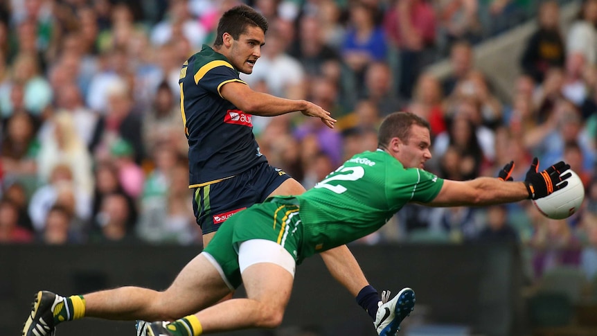 Chad Wingard kicks for Australia in International Rules match against Ireland