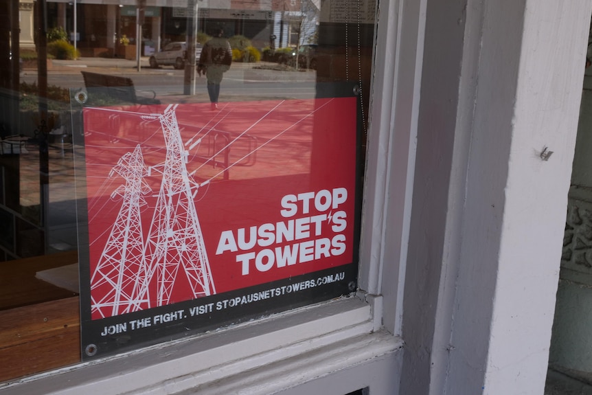 red sign which reds stop ausnet's towers in window of Creswick business