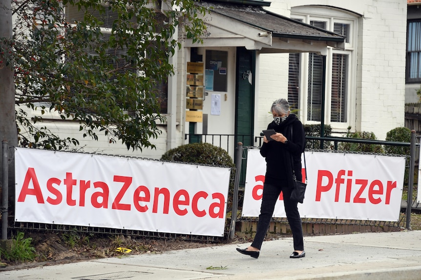 Woman walks past a vaccination clinic