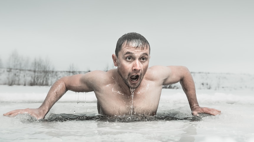 Man emerges from swimming in an ice hole