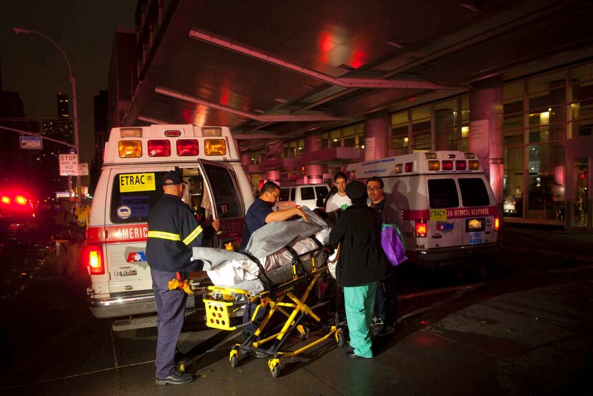 Paramedics evacuate patients from New York University Hospital due to a power outage