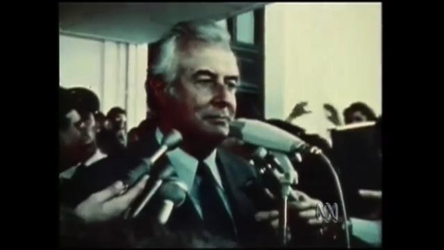 Gough Whitlam stands before press microphones on steps of Parliament House on 11 November 1975