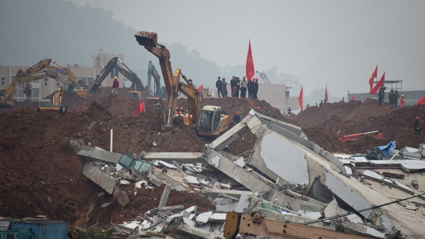Rescue workers look for survivors after a landslide hit an industrial park in Shenzhen