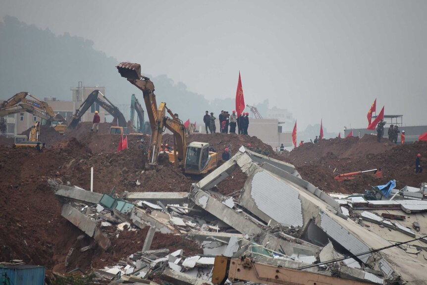Rescue workers look for survivors after a landslide hit an industrial park in Shenzhen