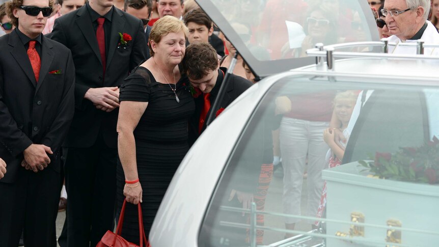 Denise Morcombe hugs her son Dean after the funeral of their son and brother, Daniel.