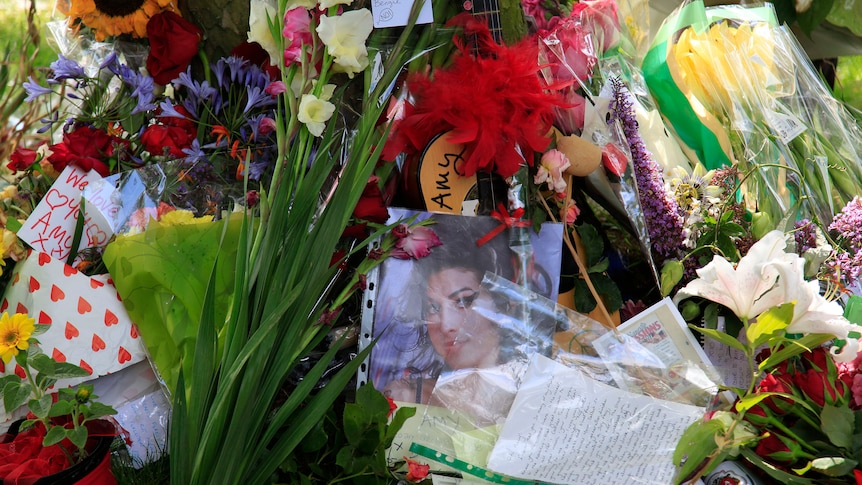 Flowers and messages are seen outside the home of Amy Winehouse in London