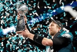 Nick Foles looks longingly at the Vince Lombardi Trophy