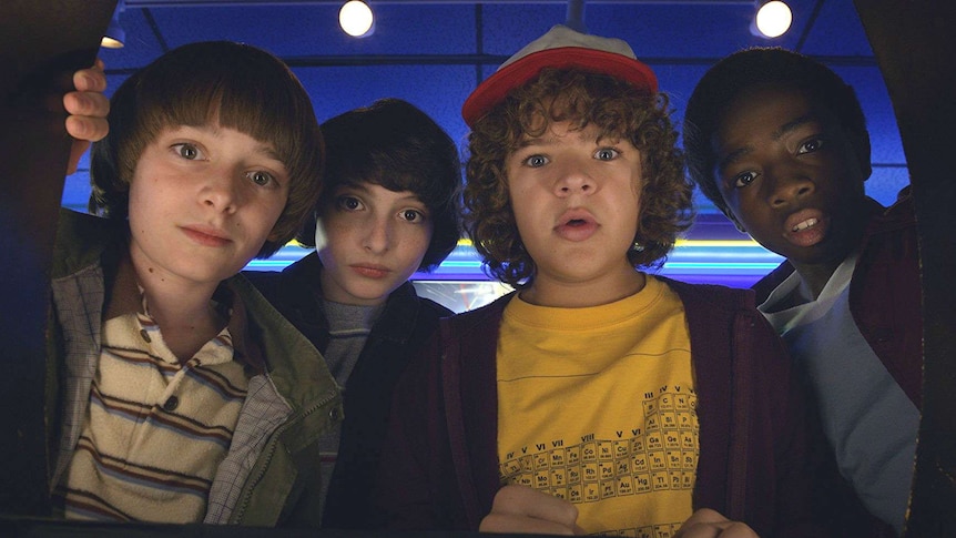 The main cast of Netflix's Stranger Things look at the camera