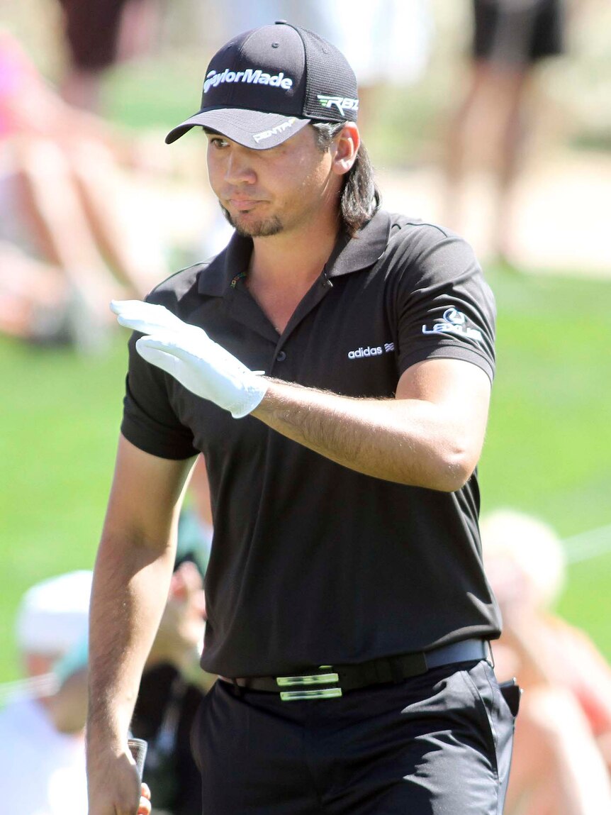 Jason Day acknowledges the crowd after sinking a putt