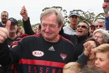 Show of faith ... Kevin Sheedy poses with fans during a Bombers training session on Thursday