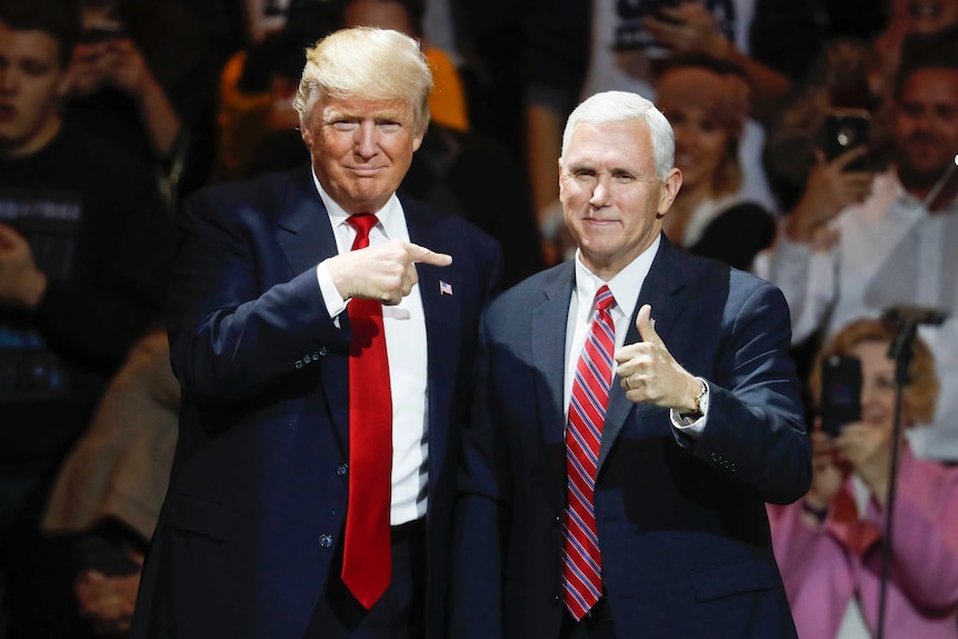 Donald Trump and Mike Pence stand on a stage together