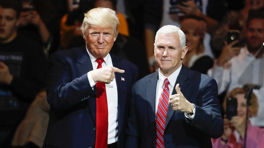 Donald Trump and Mike Pence stand on a stage together