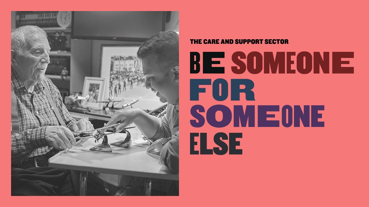 A black and white image of a young man and an old man playing chess next to the words 'be someone for someone else'.