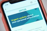 a phone screen showing an email from Optus that says "urgent updates"