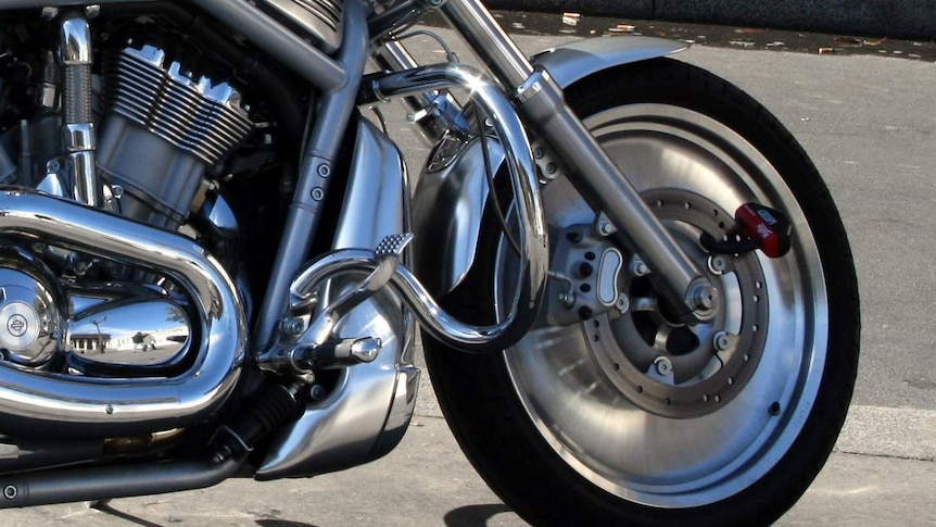 Close-up photo of the front wheel of a Harley Davidson motorbike.