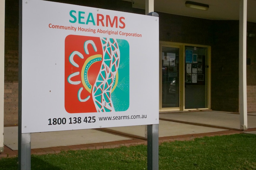 Large SEARMS sign with colourful logo outside a brick building