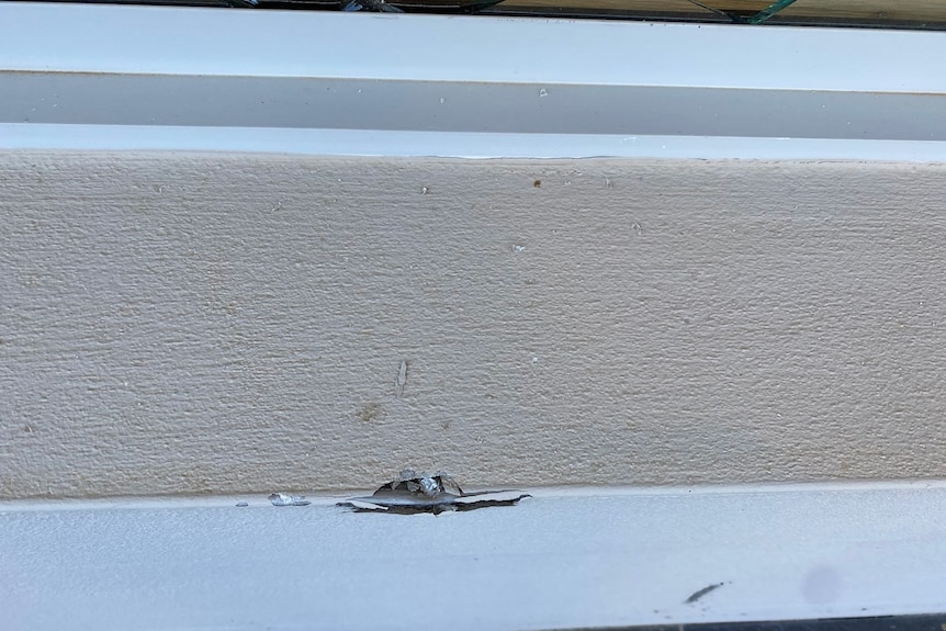 Closeup of embedded glass on a window sill.