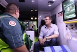 Alan Tudge in the ambulance talking to St John Ambulance volunteer Gary Alexander.
