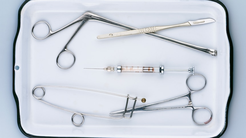 Medical implements arranged on a tray