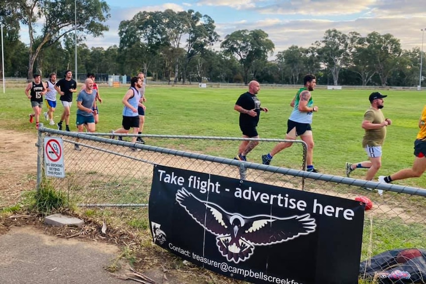 men running around a football oval