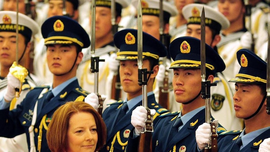 Julia Gillard walks beside Chinese premier Wen Jiabao during a review of the honour guard at the Great Hall of the People in Beijing.