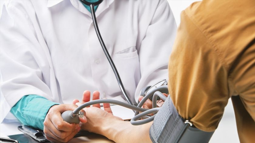 A person has their blood pressure checked.