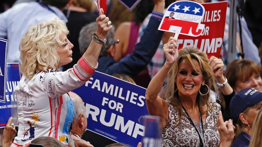 Women hold Trump signs at the Republican National Convention in Cleveland, Ohio.