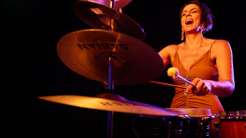 Percussionist Claire Edwardes plays a bunch of cymbals on a stand.