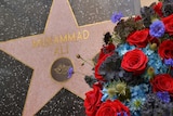 A wreath stands next to Muhammad Ali's star on Hollywood Boulevard