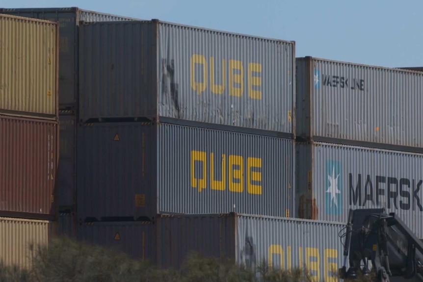Shipping containers with Qube branding at a Melbourne logisitics terminal.