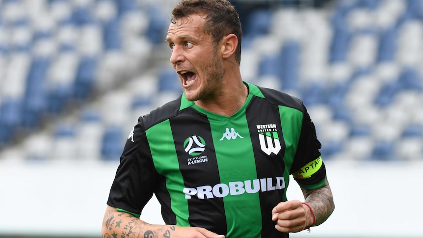 Alessandro Diamanti looks over his shoulder and opens his mouth wearing a green and black striped shirt with a yellow arm band