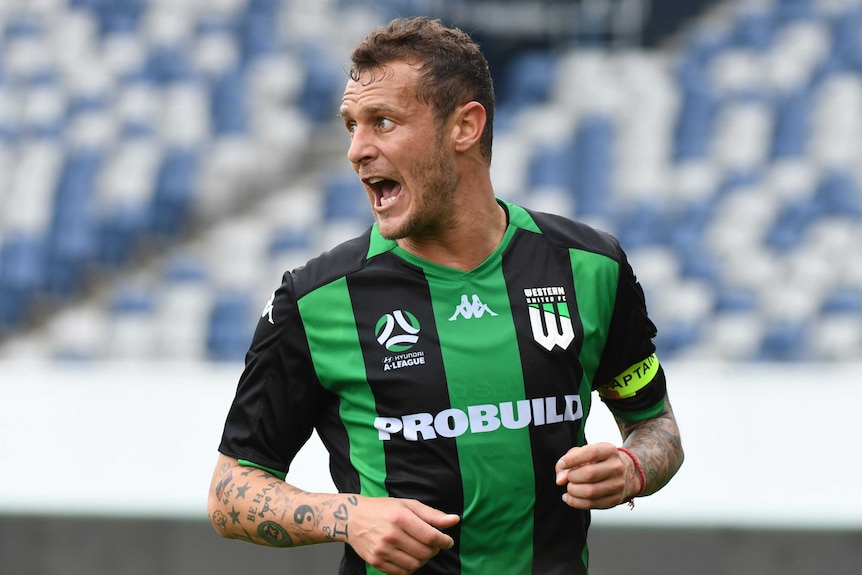 Alessandro Diamanti looks over his shoulder and opens his mouth wearing a green and black striped shirt with a yellow arm band