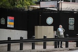 A woman waits in front of the visa application office entrance in Ankara.