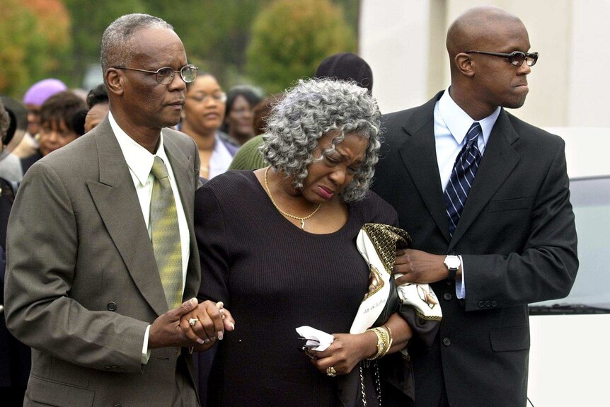 Relatives attend the funeral of the Washington D.C snipers' last victim