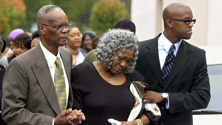 Relatives attend the funeral of the Washington D.C snipers' last victim