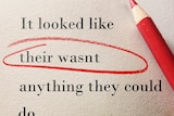 A red pencil circles spelling mistakes on a piece of paper