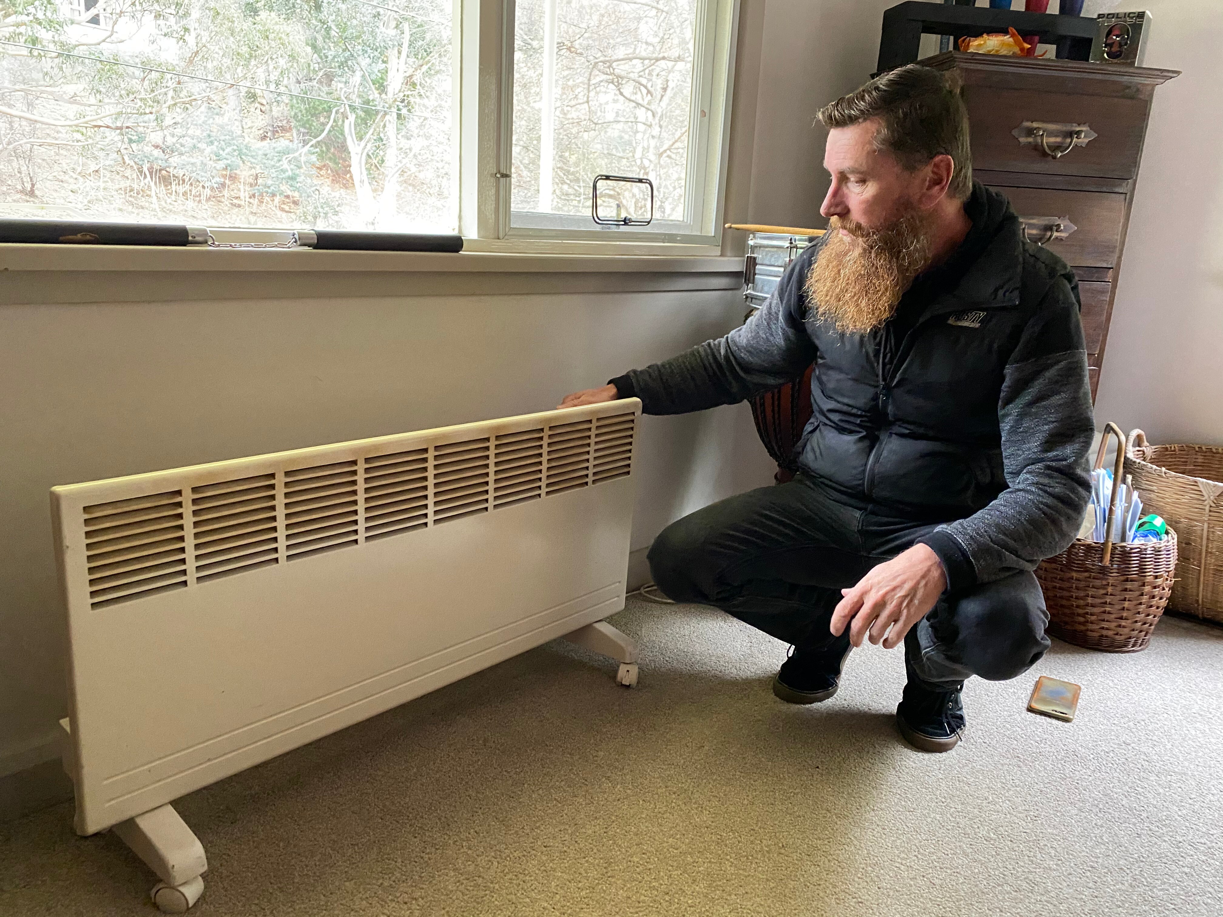 A man next to a heater.