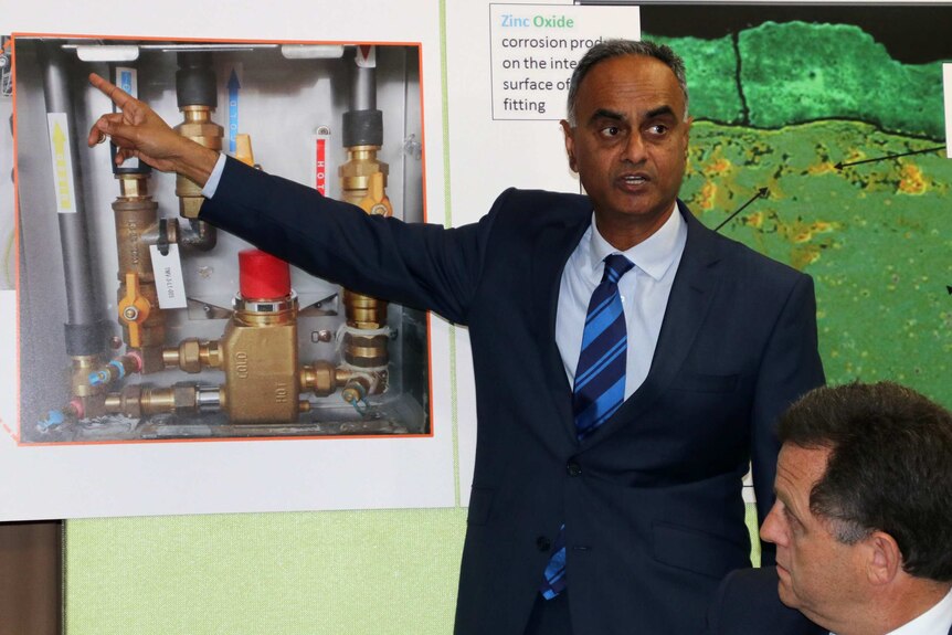 Professor Weeramanthri points to a diagram showing the brass fittings.