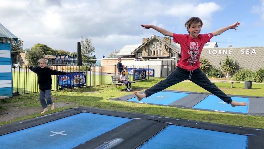 Two boys jumping on the trampolines at Lorne on Victoria's Great Ocean Road