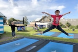 Two boys jumping on the trampolines at Lorne on Victoria's Great Ocean Road