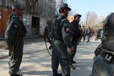 Policemen stand guard after deadly Afghan attack
