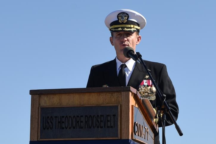 Captain Brett Crozier addressing an audience in uniform.