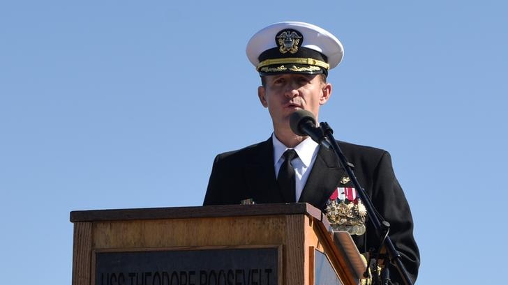 Captain Brett Crozier addressing an audience in uniform.