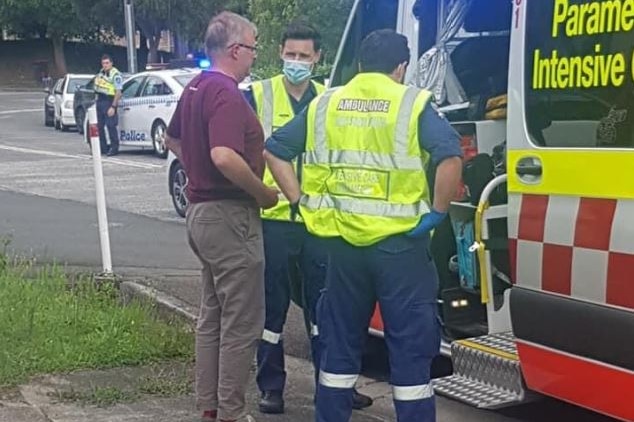 Anthony Albanese stands at ambulance with paramedics