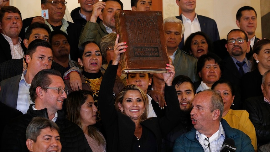 Bolivian Senator holding up a bible.