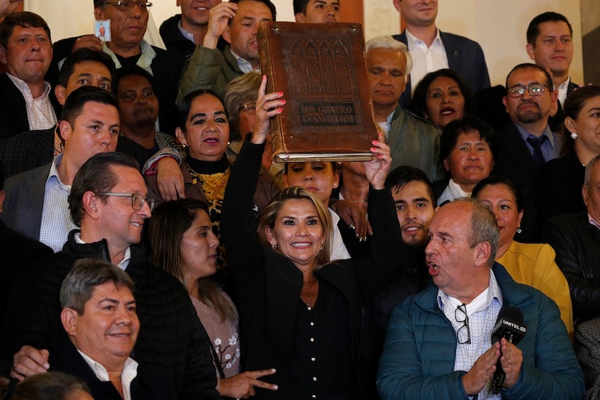 Bolivian Senator holding up a bible.