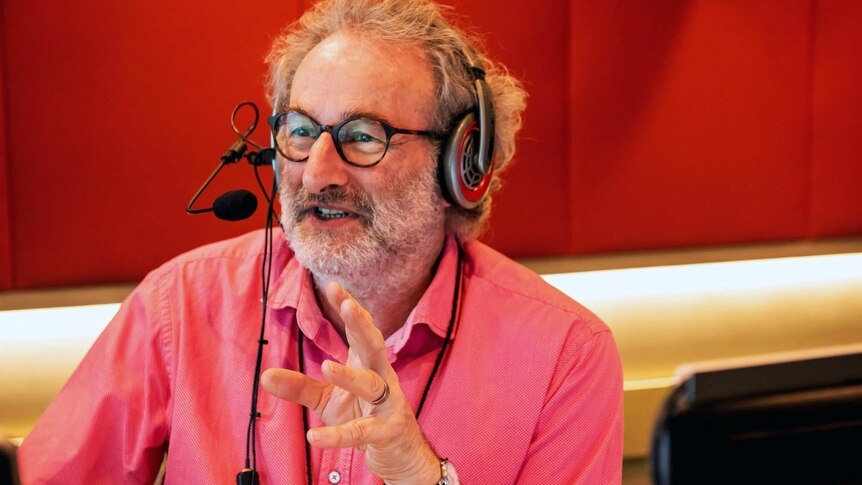 Radio host Jon Faine gestures in studio