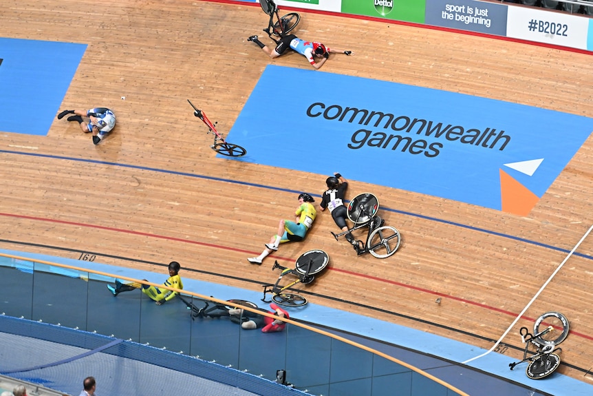 Riders lay across the track in the aftermath of the crash
