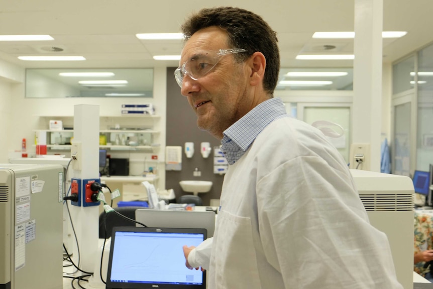 A scientist pointing at a screen